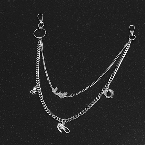Silver layered pant chain featuring mermaid and sea creature pendants on dark background