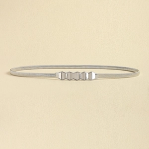 Close-up of minimalist silver metal spring belt with geometric buckle for dresses