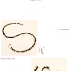 Detailed view of gold chain woven with black PU leather featuring a minimalist pin buckle