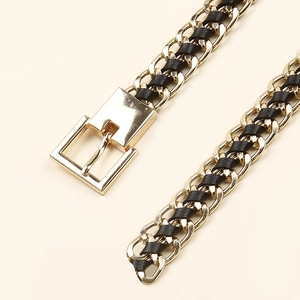 Detail of woven black leather belt with gold metal chain links and rectangular buckle