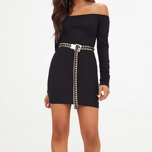 Detail of slim fit off-shoulder mini dress featuring chunky gold chain link waist belt