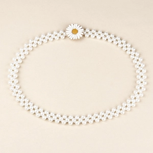 Détail de la chaîne de taille élastique en perles avec un ornement de marguerite