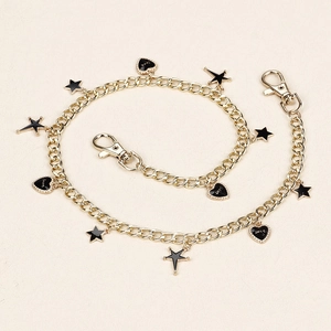 Detail of gold pant chain with black heart LOVE and star charms and lobster clasps