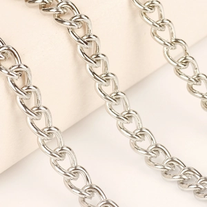 Macro shot of three-layer silver metal chains with polished finish and oval links