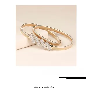 Close-up of gold metal elastic waist chain with sparkling crystal geometric buckle