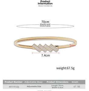 Detail view of golden elastic metal belt with rhinestone buckle and size specifications