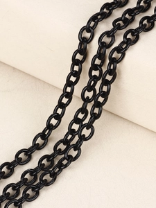 Macro shot of polished gun black layered metal pant chains for punk denim fashion