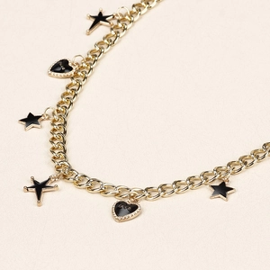 Detail of gold chain belt with black enamel stars and hearts featuring Love text