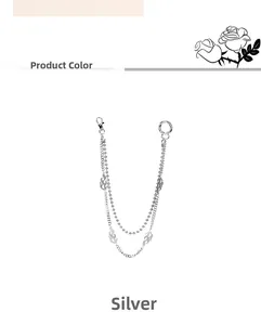 Detail of silver multi-layer metal pants chain featuring flame pendants and lobster clasp