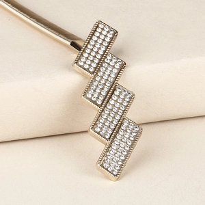 Detailed close-up of a gold elastic spring waist chain with a sparkling rhinestone buckle