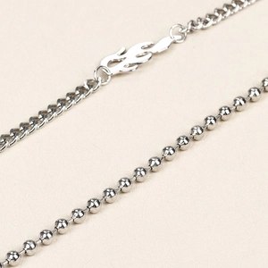 Detailed macro of punk silver flame metal pants chain with beaded and link elements