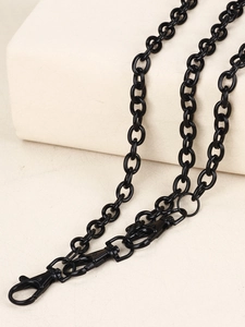 Close-up of polished gunmetal black multi-layer pants chain with lobster clasps for jeans