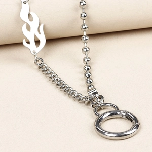 Detail of silver flame metal links and mixed chain textures on a streetwear accessory