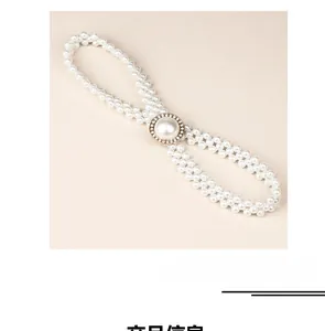 Detail of woven pearl waist chain featuring a central rhinestone-studded buckle
