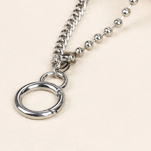 Detail of silver cuban and bead metal chains with spring clasp for punk denim styling