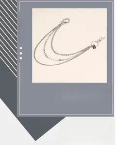 Detail of silver multi-layer punk trouser chain with heart clasp and metal tags