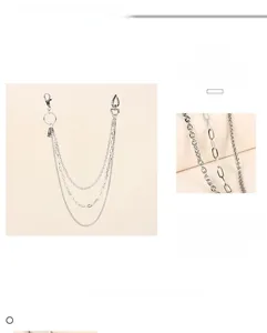 Detail view of multi-layered silver metal pant chains with sturdy lobster clasps and rings