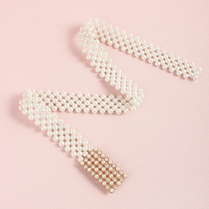 Detail van elegante parelmoer tailleketting met een rechthoekige gouden strass gesp