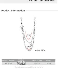 Detail of silver multi-layered metal pant chain with dragon pendant and star charms