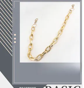 Detail of chunky gold pant chain with large oval links and lobster clasp for trousers