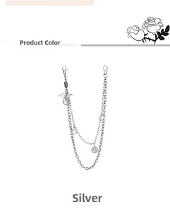 Detail of silver multilayer pant chain with dragon pendant and star ring charms