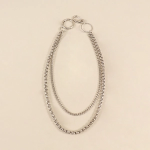Detail of double-layer silver metal trouser chain with round spring carabiner and lobster clasp