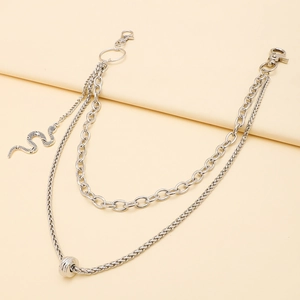 Detailed view of silver multilayered waist chain with snake pendant and lobster clasps