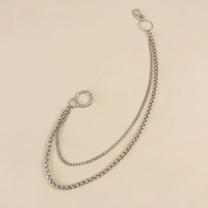 Detail of silver double-layered punk style trousers chain with lobster clasps and rings