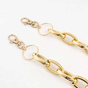 Detail of glossy gold hollow ring chain with lobster clasps for punk hip hop style pants