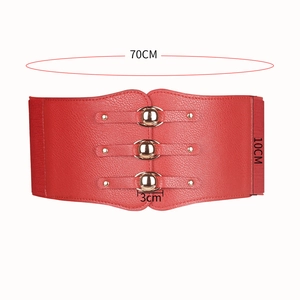 Detail view of red elastic wide belt featuring golden buckles and size measurements
