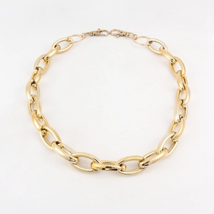 Detail of chunky gold chain link belt with lobster clasps for punk hip hop style pants