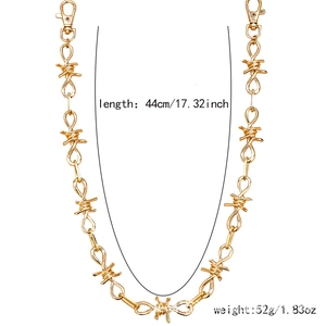 Detailed view of golden barbed wire pants chain with dimensions of 44cm and lobster clasps