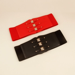 Detail of red and black elastic corsets with three golden metal buckles and leather texture