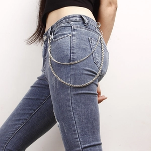 Close-up of double-layer silver metal pants chain with rings on blue jeans