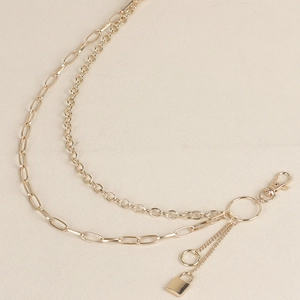Gold-tone layered metal body chain with classic rings and solid padlock pendant