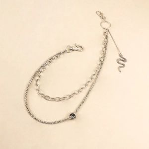 Detail of silver double-layered chain with snake pendant and metallic lobster clasps