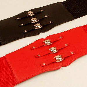 Detailed view of elastic wide belts in red and black with golden metal buckles