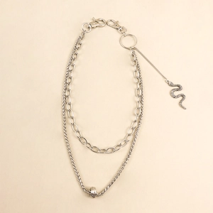 Detail of silver double-layered pant chain featuring snake pendant and ring buckle
