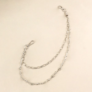Close-up of double-layered silver punk waist chain with barbed wire and lobster clasps