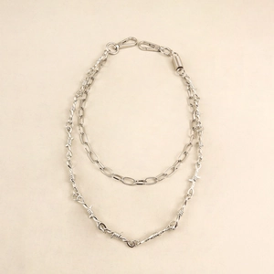 Detail of silver double-layered punk pants chain with barbed wire and lobster clasp