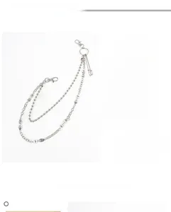 Detail of silver skull pendants on double-layered punk style metal trousers chain
