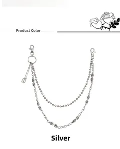 Detail of silver double-layered hip hop pant chain with skull pendant and safety pin charm