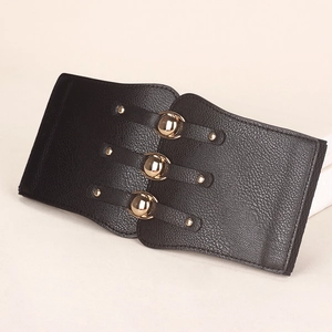 Detail of black pebbled leather waist belt with gold spherical buckles and rivets