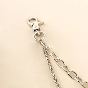 Close-up of double-layer silver metal pants chain with lobster clasp and snake-style textures