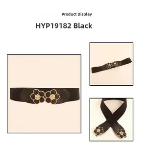 Detail view of black elastic corset belt with a gold-trimmed floral metal buckle