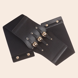 Detail view of a black wide elastic belt with gold metal buckles and rivet decorations