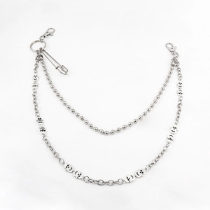 Detailed punk double layer metal trouser chain with silver skull pendants and safety pin
