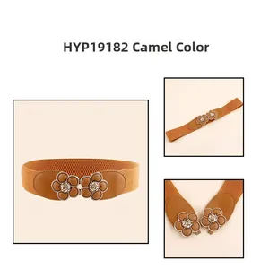 Detail of camel elastic wide belt with intricate double flower buckle design
