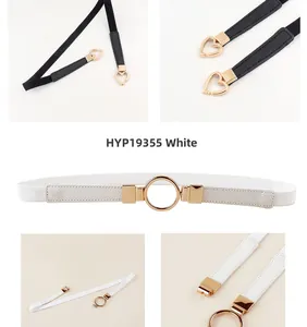 Detailed close-up of white elastic waist belt with a golden round buckle and fine stitching