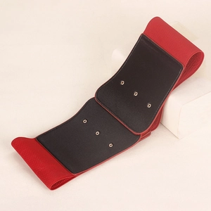 Detail view of red elastic wide waist belt with black PU leather panels and metal eyelets